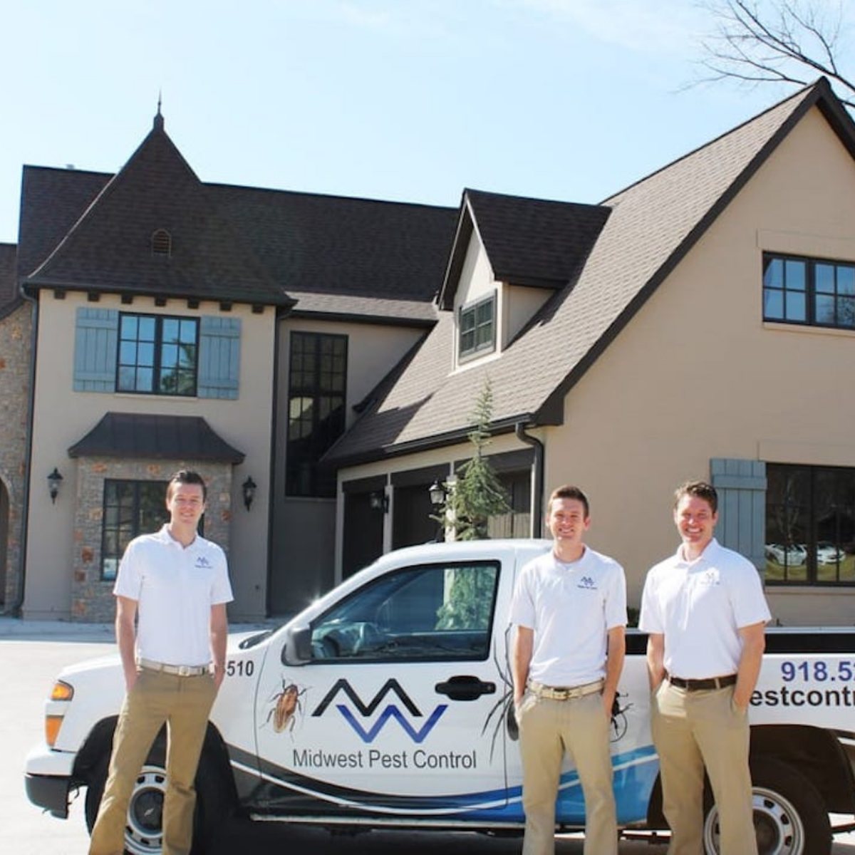 The Midwest Pest Control team beside their service truck in Tulsa, OK
